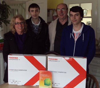 Laurence and his family with the laptop computers